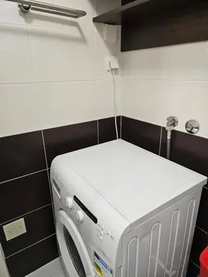 a washing machine in a room with a wall at Sweet Pleasure in Belgrade