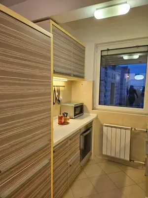 a kitchen with a microwave and a window at Sweet Pleasure in Belgrade