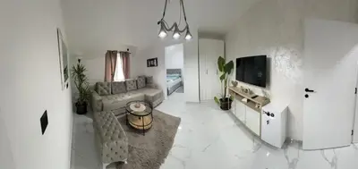 a living room with a couch and a tv at Airport vicinity Apartment Star 1 in Belgrade