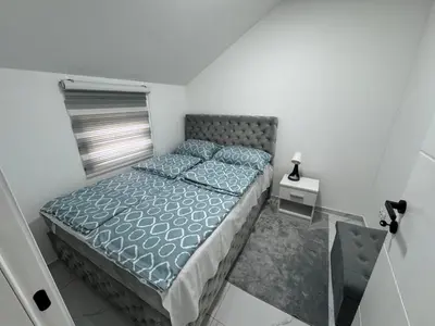 a small bedroom with a bed and a glass floor at Airport vicinity Apartment Star 1 in Belgrade