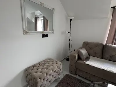 a living room with a couch and a mirror at Airport vicinity Apartment Star 1 in Belgrade
