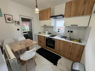 a small kitchen with a table and a sink at Airport vicinity Apartment Star 1 in Belgrade