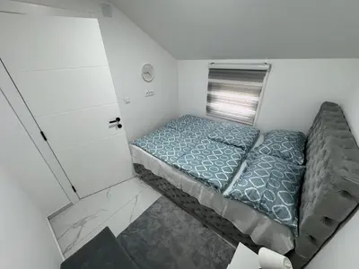 a small bedroom with a bed in a room at Airport vicinity Apartment Star 1 in Belgrade