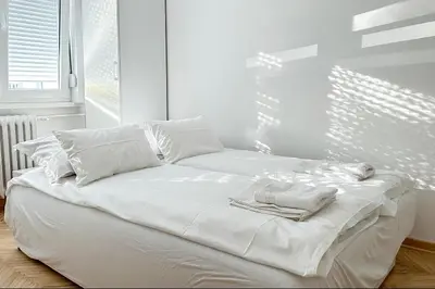 a white bed with towels on it in a room at Apartman Tašmajdan in Belgrade