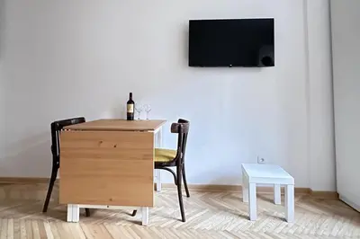 a room with a desk and a table and a tv at Apartman Tašmajdan in Belgrade
