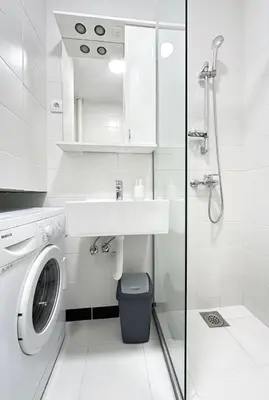 a white bathroom with a washing machine and a sink at Apartman Tašmajdan in Belgrade