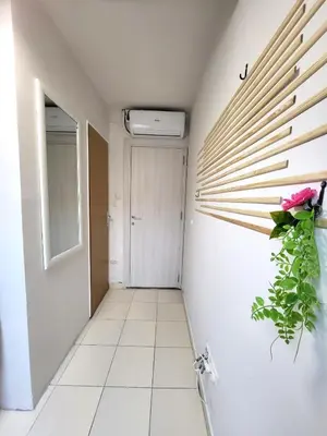 a hallway with a plant on the wall at Guesthouse Ožegović in Belgrade