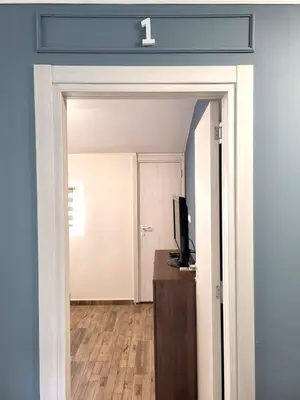 a door leading into a room with a television at Guesthouse Ožegović in Belgrade