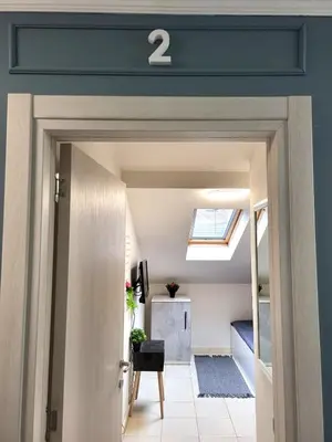 a door leading into a room with a skylight at Guesthouse Ožegović in Belgrade