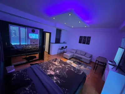 a living room with purple lights on the ceiling at Una_2 in Čukarica