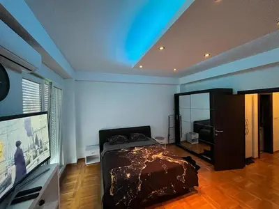 a bedroom with a bed and a flat screen tv at Una_2 in Čukarica