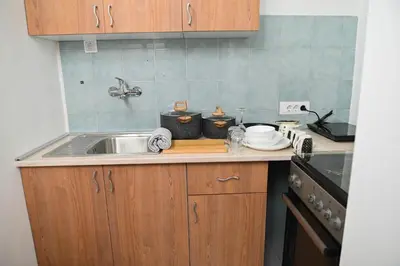 a kitchen with a sink and a counter top at Sunset Apartment in Smederevo