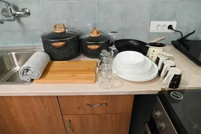 a kitchen counter with a cutting board and plates on it at Sunset Apartment in Smederevo