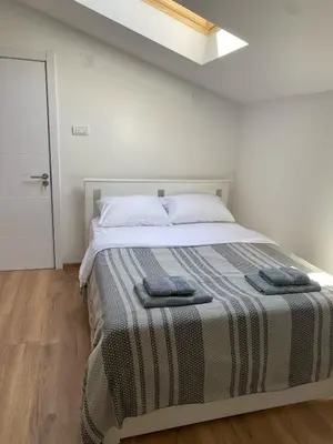 a bedroom with a bed with two towels on it at ŠTAB 1 City Centre (free parking) Dorćol in Belgrade