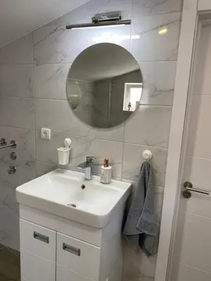 a bathroom with a white sink and a mirror at ŠTAB 1 City Centre (free parking) Dorćol in Belgrade