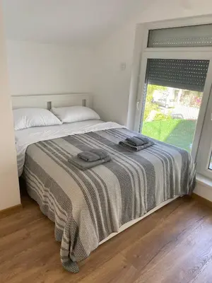 a bedroom with a bed with two towels on it at ŠTAB 1 City Centre (free parking) Dorćol in Belgrade