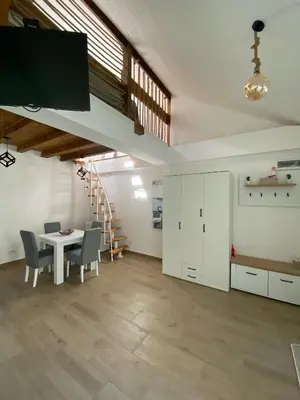 a room with a table and chairs and a staircase at ŠTAB 2 City Centre (free parking) Dorcol in Belgrade