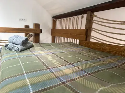 a bed with a blanket and two towels on it at ŠTAB 2 City Centre (free parking) Dorcol in Belgrade