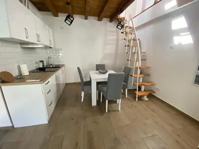 a kitchen with a table and chairs and a staircase at ŠTAB 2 City Centre (free parking) Dorcol in Belgrade