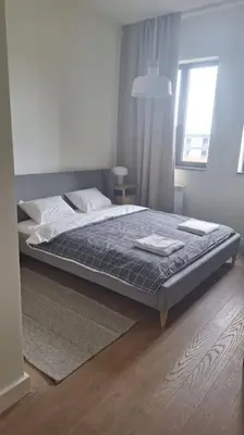 a bedroom with a bed and a window at Crown Apartments - BW Sole in Belgrade