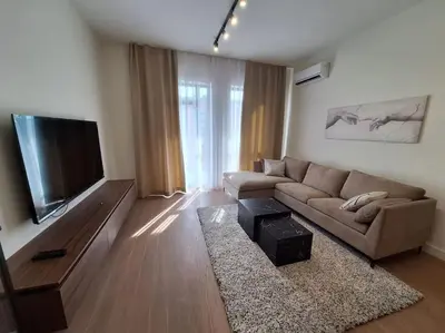 a living room with a couch and a flat screen tv at Crown Apartments - BW Sole in Belgrade