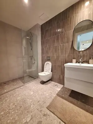 a bathroom with a toilet and a sink and a shower at Crown Apartments - BW Sole in Belgrade