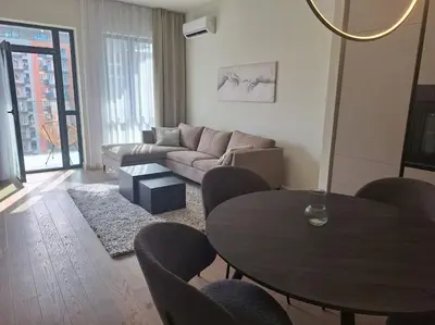 a living room with a table and a couch at Crown Apartments - BW Sole in Belgrade