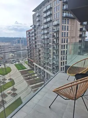 a balcony with chairs and a view of a city at Crown Apartments - BW Sole in Belgrade