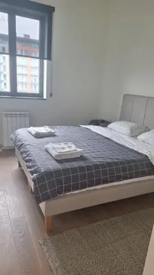 a bedroom with a bed with two towels on it at Crown Apartments - BW Sole in Belgrade