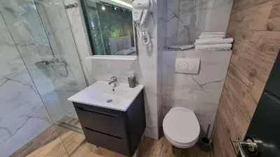 a bathroom with a toilet and a sink and a shower at B&B Botel Charlie in Belgrade