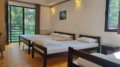 a room with three beds and a window at B&B Botel Charlie in Belgrade