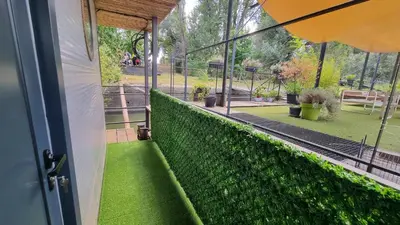a balcony with green grass and a view of a park at B&B Botel Charlie in Belgrade