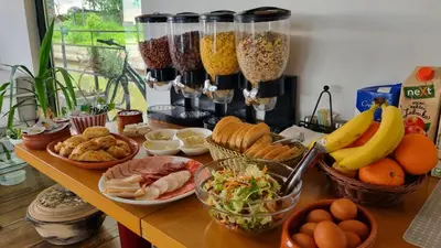 a table topped with lots of different types of food at B&B Botel Charlie in Belgrade