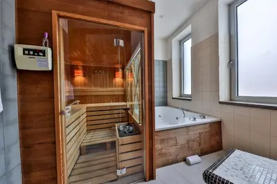 a bathroom with a tub and a shower and a bath tub at Atera Business Suites in Belgrade
