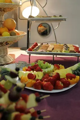 a table topped with two plates of fruit and pastries at Atera Business Suites in Belgrade