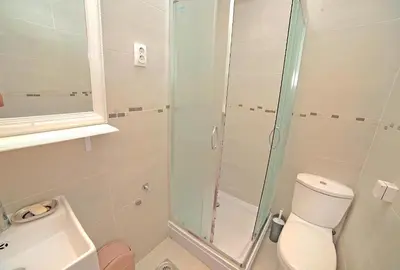 a bathroom with a toilet and a glass shower at Apartment Central in Belgrade