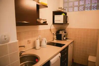 a small kitchen with a sink and a microwave at Apartment Arena White in Belgrade
