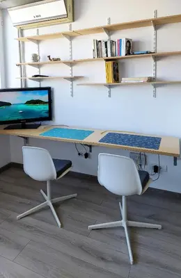 an office with two chairs and a desk with a computer at Cozy studio apartment in Belgrade