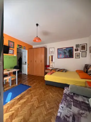 a bedroom with a bed and a desk in it at Orange Place Studio in Belgrade