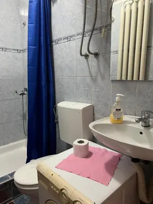 a bathroom with a toilet and a sink and a bath tub at Orange Place Studio in Belgrade