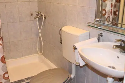 a bathroom with a toilet and a sink at Orange Place Studio in Belgrade