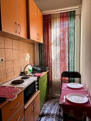 a small kitchen with a stove and a table with at Orange Place Studio in Belgrade