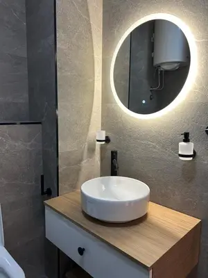 a bathroom with a white sink and a mirror at RED RIDING HOOD in Belgrade