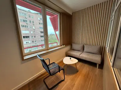 a small living room with a chair and a table at RED RIDING HOOD in Belgrade
