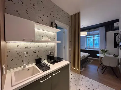 a kitchen with a sink and a room with a bed at RED RIDING HOOD in Belgrade
