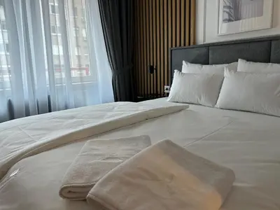 a large white bed with two towels on it at RED RIDING HOOD in Belgrade