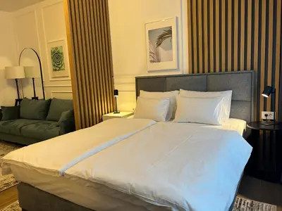 a bedroom with a large bed and a couch at RED RIDING HOOD in Belgrade