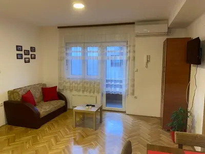 a living room with a couch and a table at Apartman Ljubica in Arandjelovac