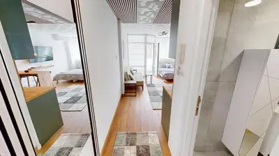 a hallway with a mirror and a living room at Luka in Belgrade