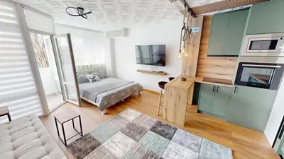 a living room with a bed and a kitchen at Luka in Belgrade